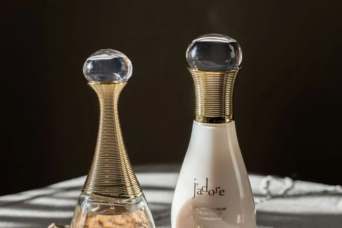 A catalog-style hero shot of two perfume bottles on a marble surface
